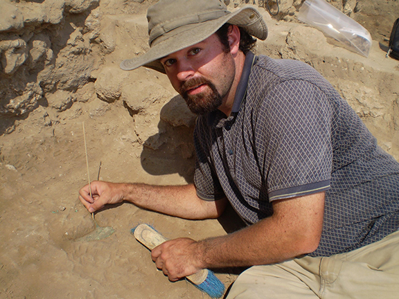 Dr. Walt making a discovery on an archaeological dig.